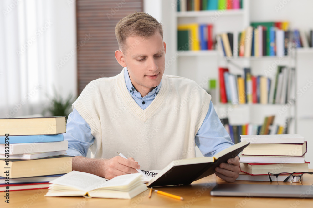 Student preparing for exam at table indoors Student preparing for exam at table indoors