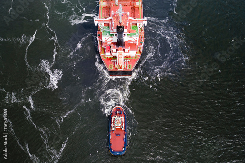 A asd tugboat assisting a bulkcarrier, Ijmuiden, The Netherlands photo