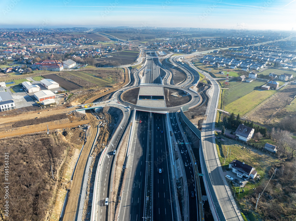 Krakow, Poland. Zielonki highway junction with traffic circle on S52 highway, part of motorway ring road around Cracow, opened for traffic on December 23, 2024. Viaducts, tunnels, ramps. Aerial view