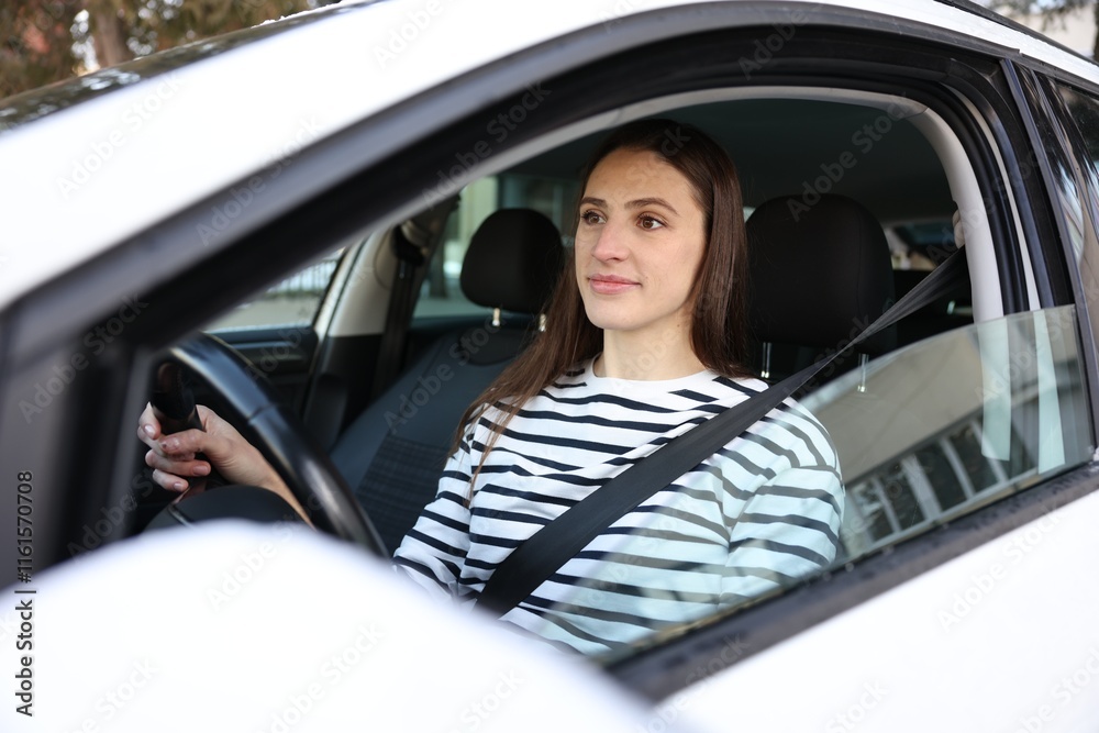 Driver behind steering wheel of modern car, view from outside Driver behind steering wheel of modern car, view from outside