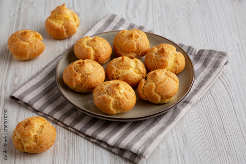 Valokuva Homemade French Mini Cream Puffs on a Plate, side view.