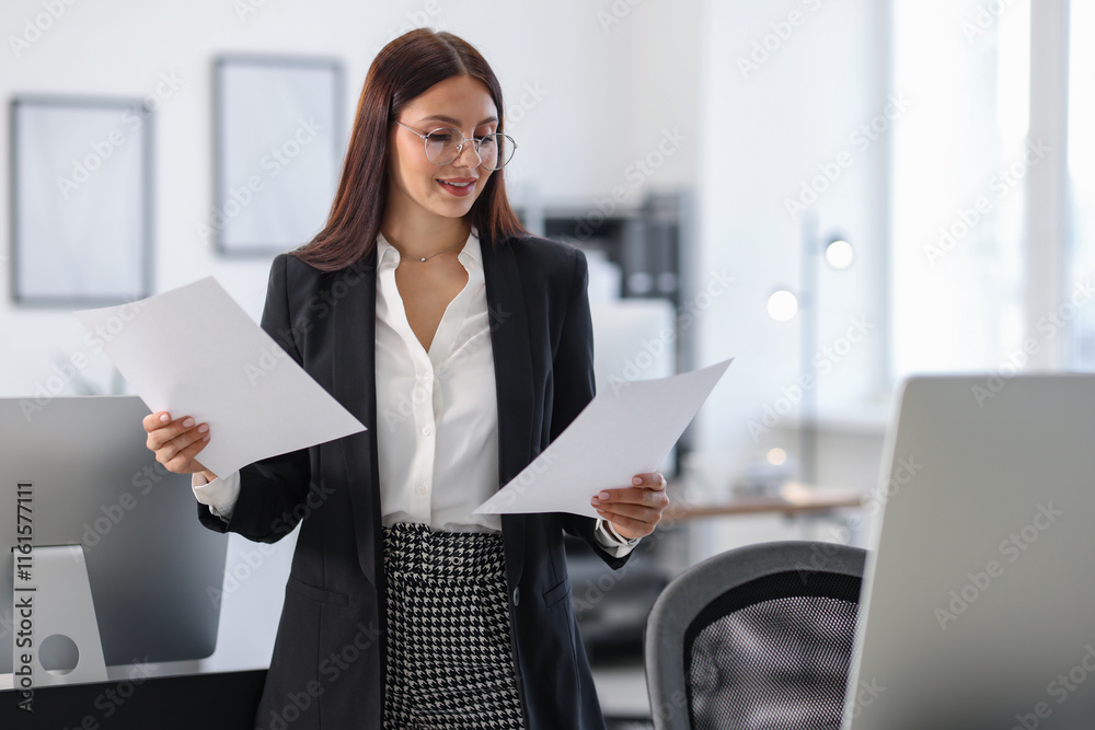 Portrait of banker with documents in office Portrait of banker with documents in office