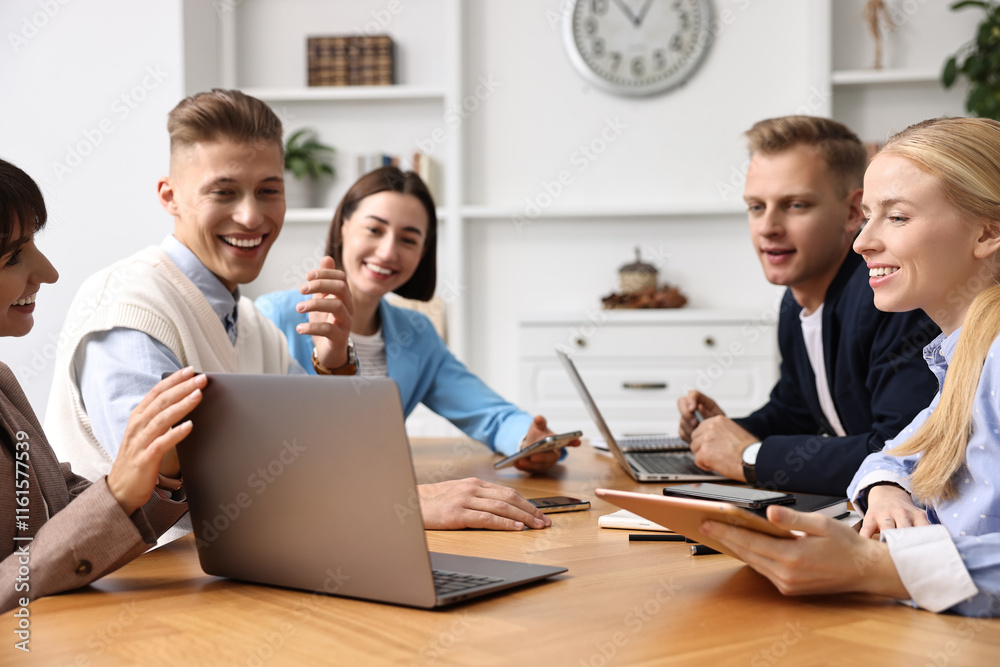 Group of people using different gadgets at wooden table in office. Modern technology Group of people using different gadgets at wooden table in office. Modern technology