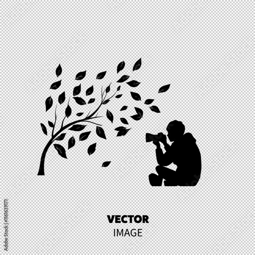 Silhouette of a young photographer capturing nature as leaves swirl in the breeze.