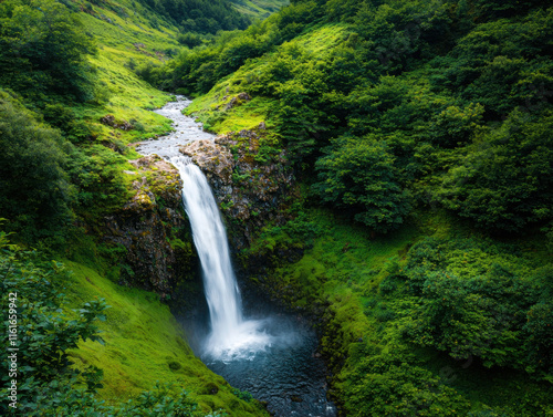 A serene waterfall cascades through lush greenery, surrounded by vibrant hills and a tranquil river, creating a picturesque natural landscape.
