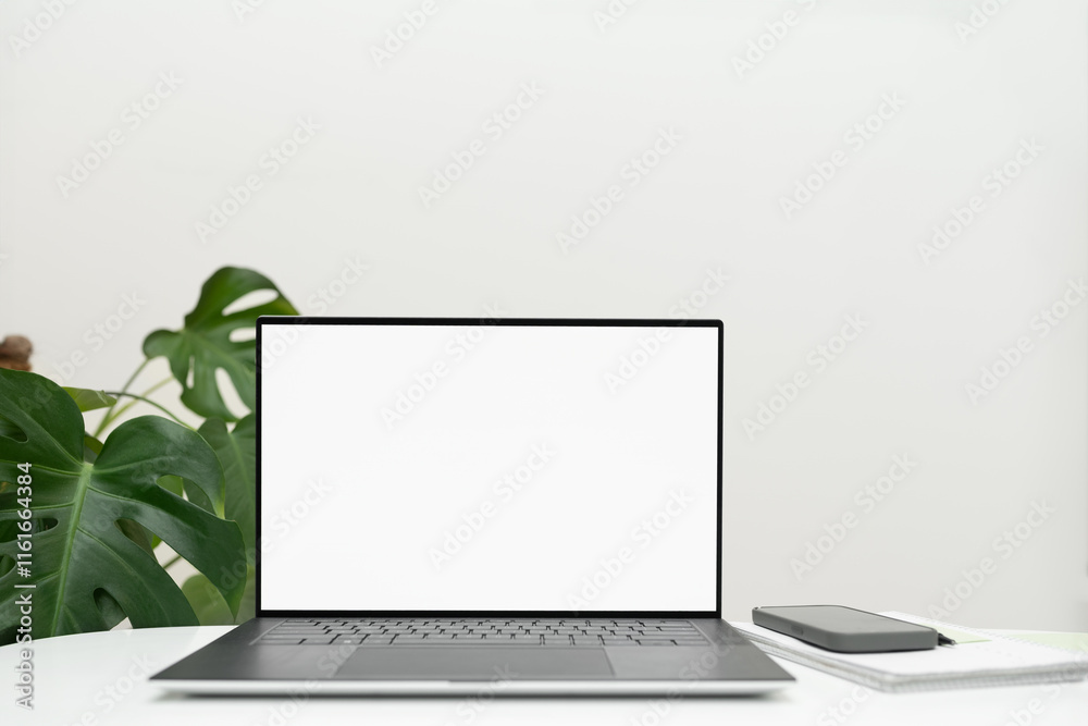 workspace with blank laptop computer with white screen for mockups, on white surface,Copy space workspace with blank laptop computer with white screen for mockups, on white surface,Copy space