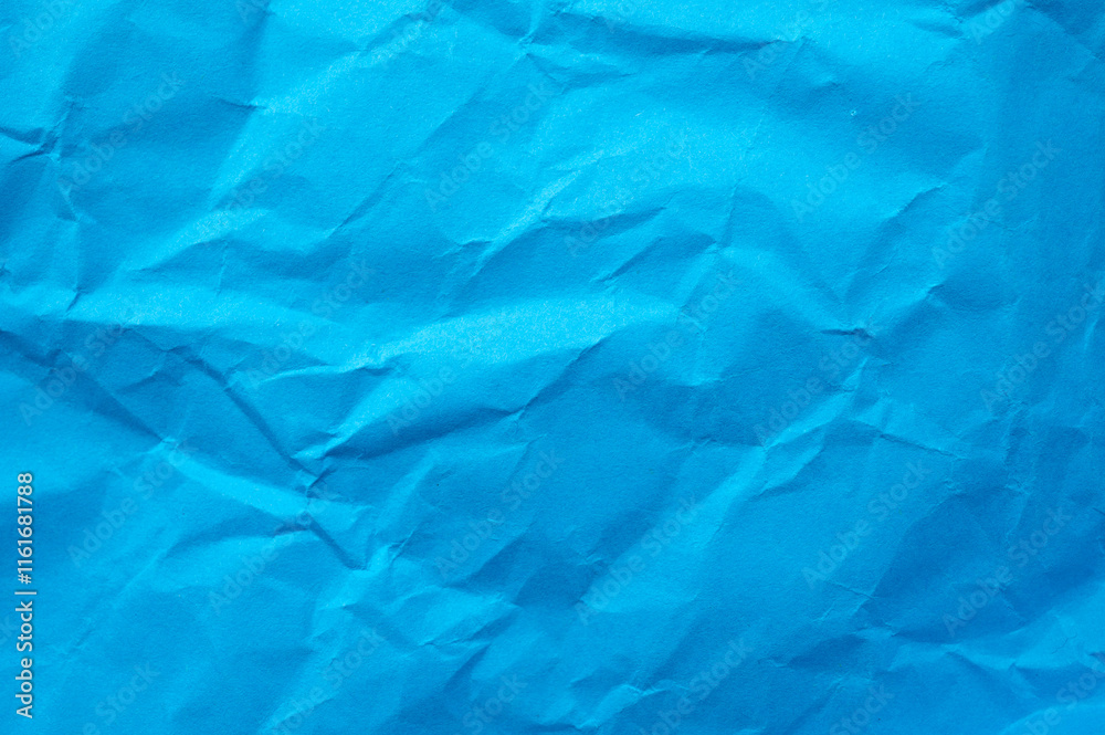 Obraz premium Full frame shot of crumpled blue paper sheet texture and background.