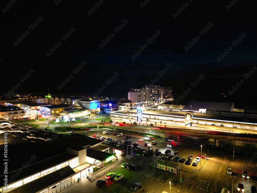 Obraz premium Aerial View of Illuminated Brighton Beach and Ocean City and British Tourist Attraction of East Sussex, England Great Britain During Night. Drone's Camera Footage Captured on December 3rd, 2024