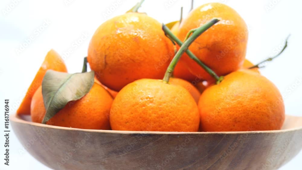 Rotating view of fresh mandarin oranges with green stems in a wooden bowl, highlighting their vibrant color and natural appeal.
Rotating view of fresh mandarin oranges with green stems in a wooden bowl, highlighting their vibrant color and natural appeal.