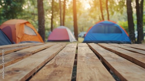 Wood table and Blurred camping and tents in forest.