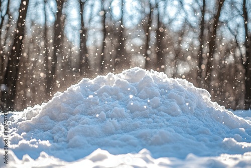 Sunlit snowdrift with falling snowflakes in a winter forest. photo