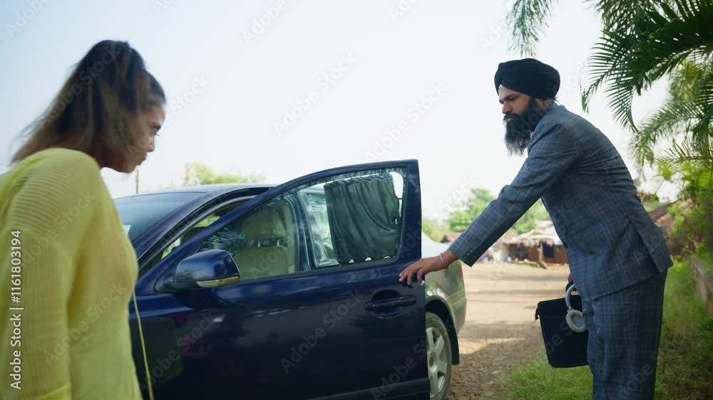 Manager opens the vehicle door for his lady boss Manager opens the vehicle door for his lady boss
