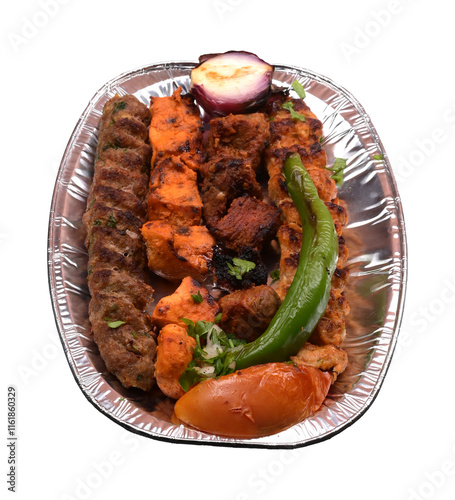 Mixed grill medium platter with tomato, onion and green chilli in a plate