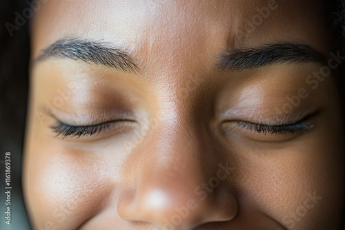 Close-up of a woman scrunching her nose and smiling with squinty eyes photo