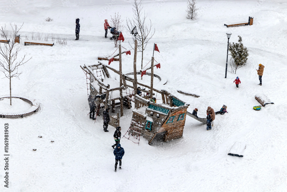 A picturesque snowy playground filled with cheerful children happily enjoying various winter activities and fun