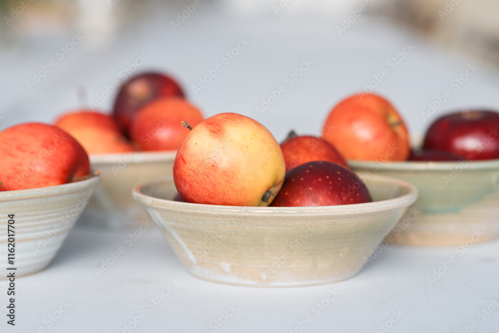 bowls of home grown apples ready for tables in a cafe bowls of home grown apples ready for tables in a cafe