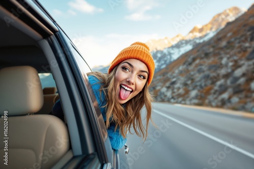 Woman in orange hat leans out car window, smiling playfully with tongue out, scenic mountain road in background, cheerful travel concept, Ai generative photo