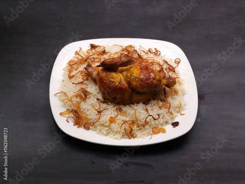 Shawai chicken Peshawar rice in a white ceramic plate in a dark background