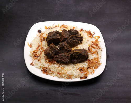 deep fried pepper beef Peshawar rice in a white ceramic plate in a dark background photo