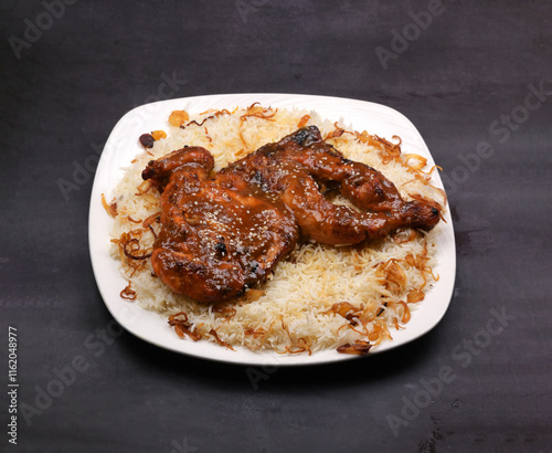 Honey glazed fried chicken Peshawar rice in a white ceramic plate in a dark background photo