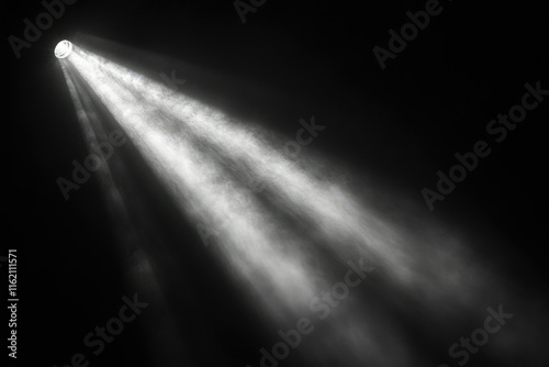 A single spotlight illuminates a dark space, creating dramatic beams of light and atmospheric dust motes.