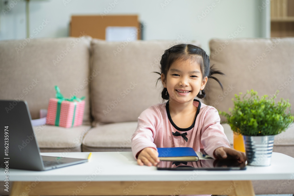 Attentive daughter writing in notebook while sitting at desk and doing homework. Attentive daughter writing in notebook while sitting at desk and doing homework.