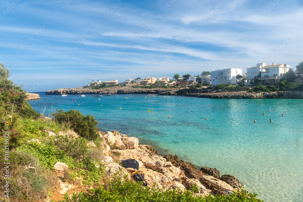 Tourists swimming in the clear water of cala domingos beach, mallorca Tourists swimming in the clear water of cala domingos beach, mallorca