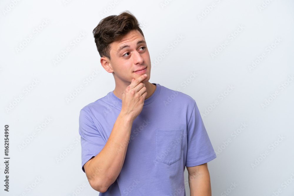 Young handsome Brazilian man isolated on white background and looking up Young handsome Brazilian man isolated on white background and looking up