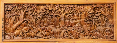 Intricate wood relief carving at the monastery located at the temple of Wat Paknam Phasi Charoen in Bangkok, Thailand.
