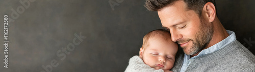 Tender fatherhood moment with dad holding sleeping baby close