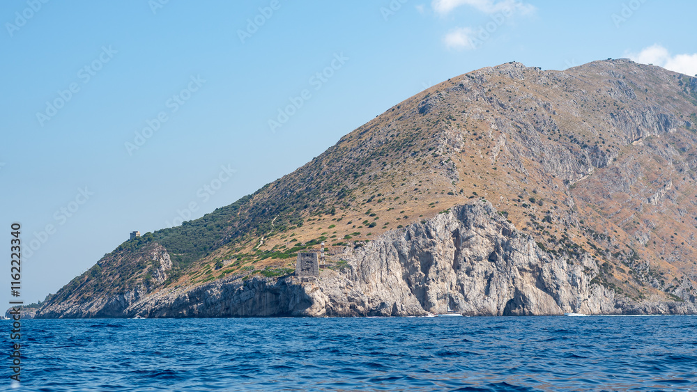 Punta Campanella with its ancient Saracen Tower viewed from the sea. A breathtaking perspective of the Amalfi Coast, Italy, perfect for travel and historical projects. Punta Campanella with its ancient Saracen Tower viewed from the sea. A breathtaking perspective of the Amalfi Coast, Italy, perfect for travel and historical projects.