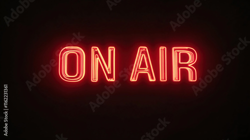 A neon sign reads “On Air” in red letters on a dark background. The sign is illuminated and he glows in the dark.