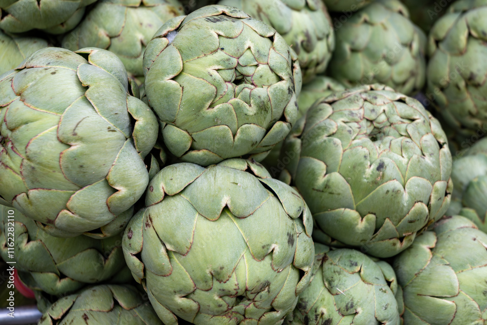 Fresh ripe green organic artichokes heads on local farmers market in Dordogne, France Fresh ripe green organic artichokes heads on local farmers market in Dordogne, France