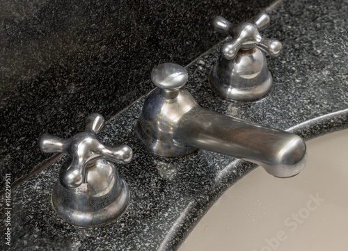 Obraz na płótnie Detail of shining chrome faucet tap on a bathroom sink. Close-up of Vintage water tap mixer cold hot water in Bathroom, use it as your Wallpaper, Poster and Copy space, Selective focus. w salonie