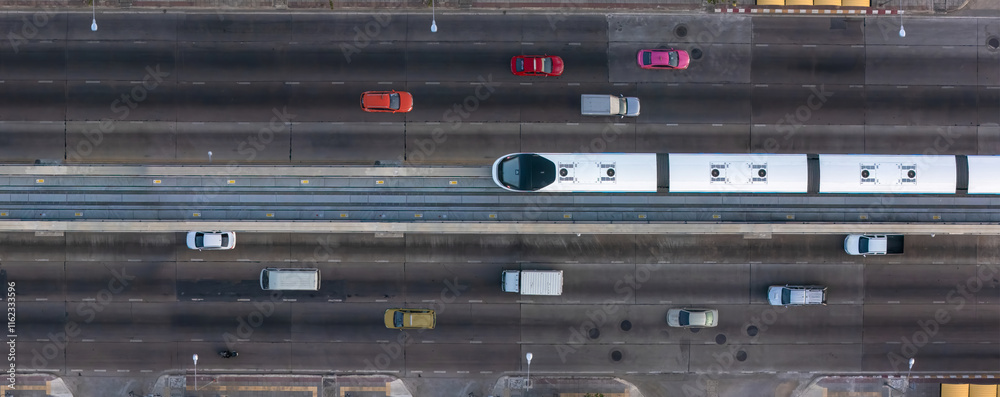 custom made wallpaper toronto digitalA top-down view of a multi-lane urban road with a central elevated rail track, surrounded by vehicles on both sides, showcasing modern city transportation infrastructure.