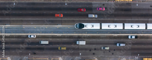 Wallpaper Mural A top-down view of a multi-lane urban road with a central elevated rail track, surrounded by vehicles on both sides, showcasing modern city transportation infrastructure. Torontodigital.ca