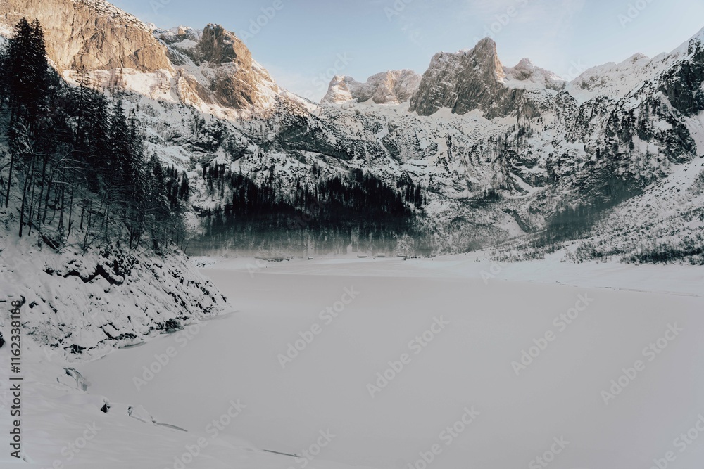 Fototapeta premium Mountain scenery in the Alps with Dachstein summit reflecting in Lake Gosausee, Salzkammergut, Austria in the Winter 