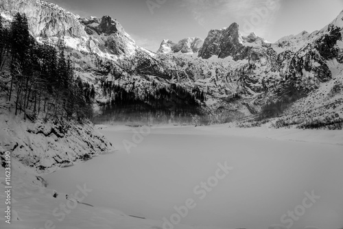 Mountain scenery in the Alps with Dachstein summit reflecting in Lake Gosausee, Salzkammergut, Austria in the Winter 