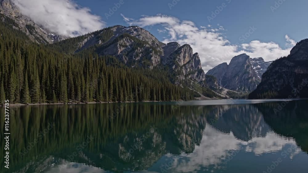 A serene mountain lake reflecting towering peaks and lush forests under a clear blue sky, perfect for nature lovers and adventurers. A serene mountain lake reflecting towering peaks and lush forests under a clear blue sky, perfect for nature lovers and adventurers.
