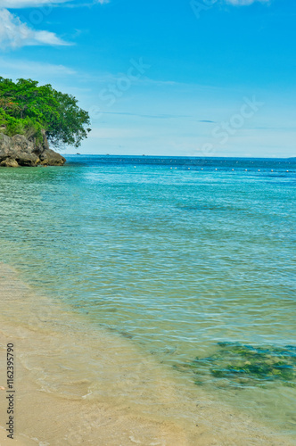 
ALONA BEACH, PHILIPPINES-2024-12-21: Beautiful beach with blue waters and tourists boats, white sand and clear sky at Alona Beach, Bohol, Philippines. This was during the Christmas week.  photo