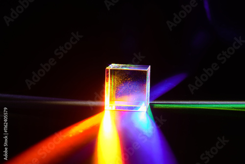 Obraz na płótnie A glass dichroic prism disperse light into different colors on a black background w salonie