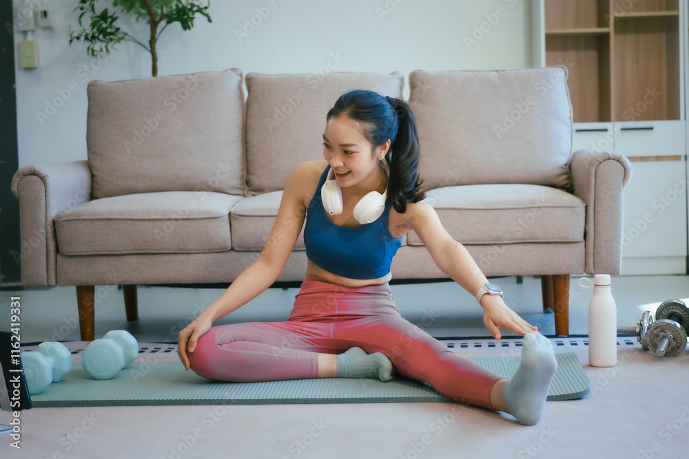 Obraz premium An Asian teenage girl exercises in her room to relax, stretch, and improve health.Regular exercise enhances endurance,strength, balance, emotional control, fitness, and aids in effective weight loss
