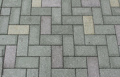 Green, gray and brown paving tile. Brick pavement texture. Interlocking concrete pavers background.