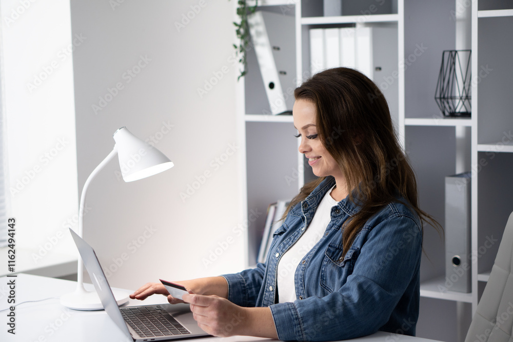 A woman is seen engaging in online shopping while working in a modern workspace, highlighting the blend of business and consumerism, showcasing the convenience of digital ecommerce today A woman is seen engaging in online shopping while working in a modern workspace, highlighting the blend of business and consumerism, showcasing the convenience of digital ecommerce today