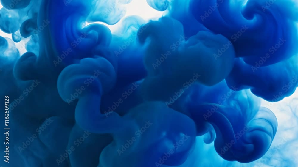 Blue ink swirling in water creating abstract