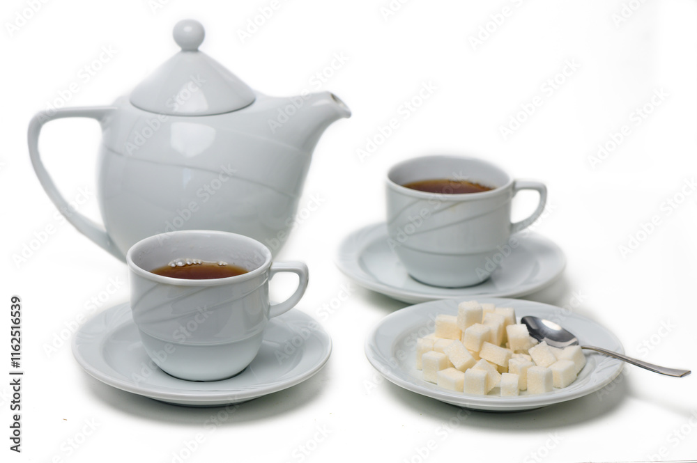 Warm tea served in elegant cups with sugar cubes on a delicate plate, perfect for a cozy afternoon break Warm tea served in elegant cups with sugar cubes on a delicate plate, perfect for a cozy afternoon break