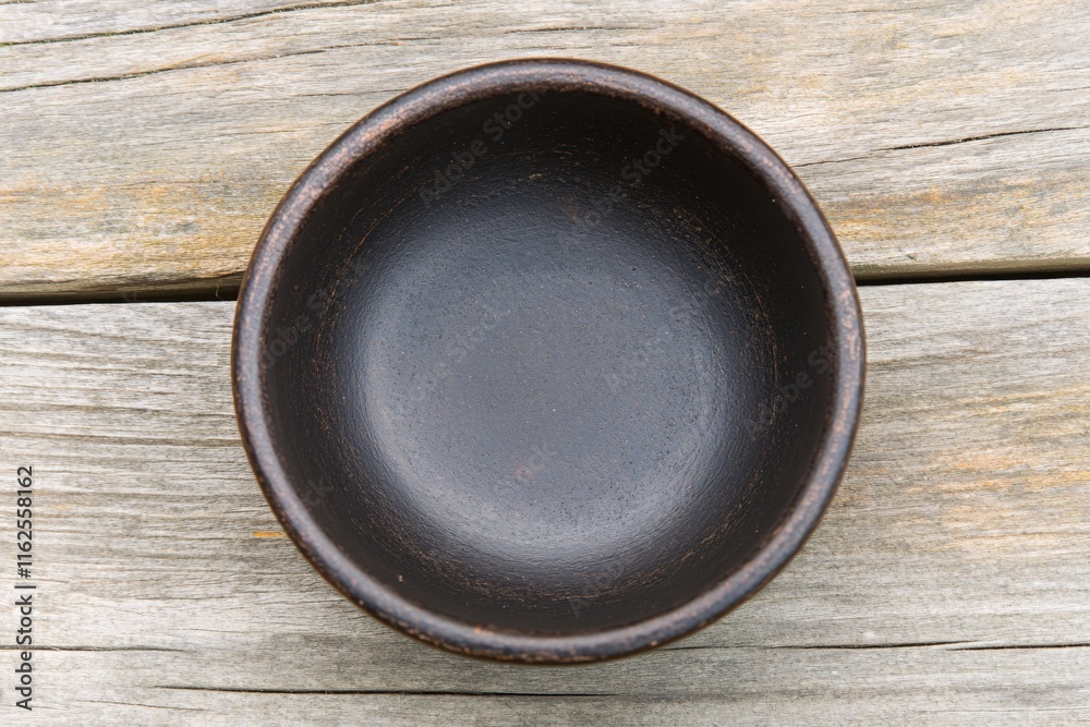 Rustic Round Clay Bowl on Weathered Wooden Table Surface for Natural Decor Rustic Round Clay Bowl on Weathered Wooden Table Surface for Natural Decor