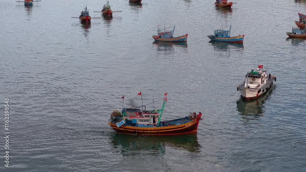 Fishing village with boats anchored harbor in Mui Ne, Binh Thuan. Royalty high-quality free best stock of traditional Vietnamese fishing boat anchor on local port. Popular landmark, famous destination Fishing village with boats anchored harbor in Mui Ne, Binh Thuan. Royalty high-quality free best stock of traditional Vietnamese fishing boat anchor on local port. Popular landmark, famous destination