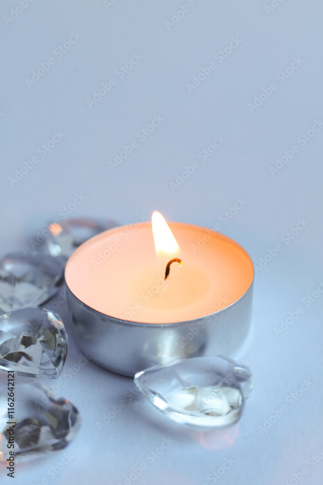 Candle and crystal stones on white background. Copy space for text.	