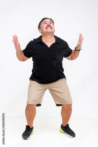 A middle-aged fan in a black polo shirt and khaki shorts struggles not to be squished in the middle by two unseen forces. For editing purposes. Isolated on a white background. Whole body photo.